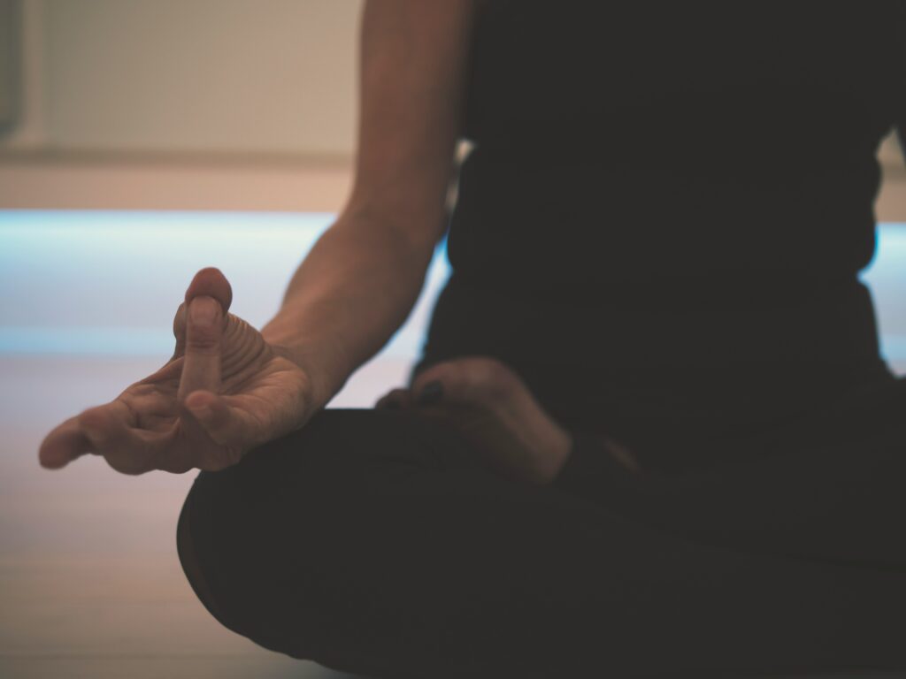 Person meditating with a mudra.