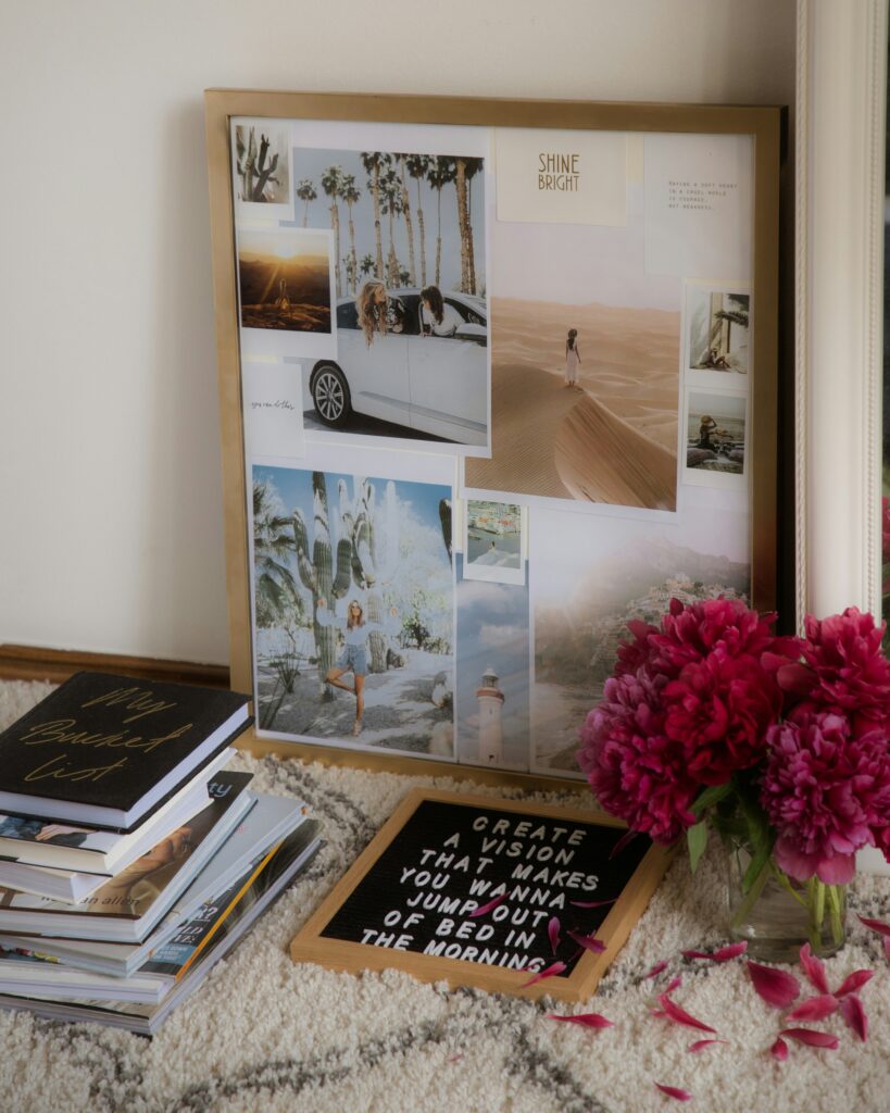Vision board with a sign in front that says "create a vision that makes you wanna jump out of bed in the morning."