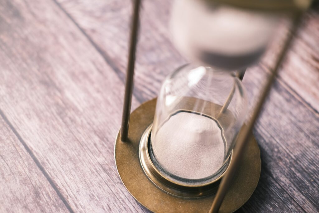 Hourglass on a wooden table.