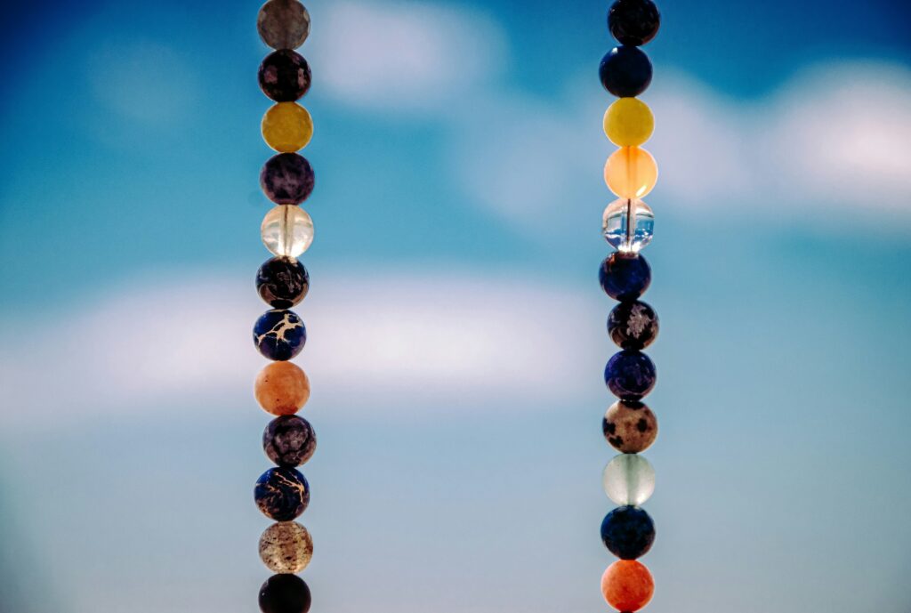 Crystal mala beads hanging in the foreground.